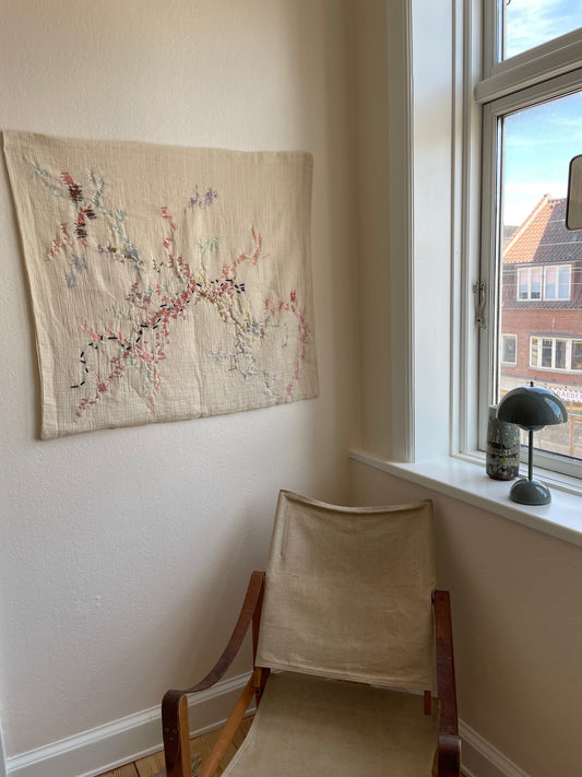 Andrea - Handcrafted Wall Hanging, fully hand embroidered 80x80 cm, displayed on a living room wall. 
