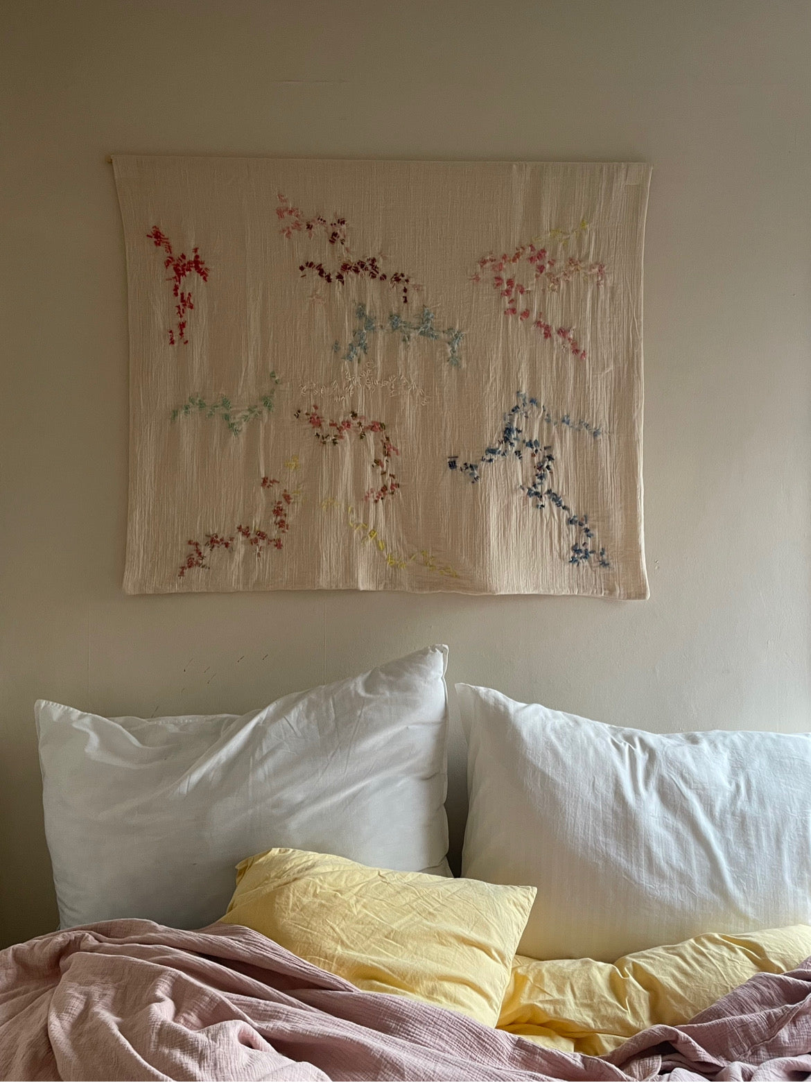 Aya -Handcrafted Wall Hanging, fully embroidered 120x100 cm, displayed on a bedroom wall.