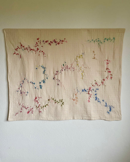 Fanny - Handcrafted wall hanging, fully hand embroidered 120x100 cm, displayed on a white wall