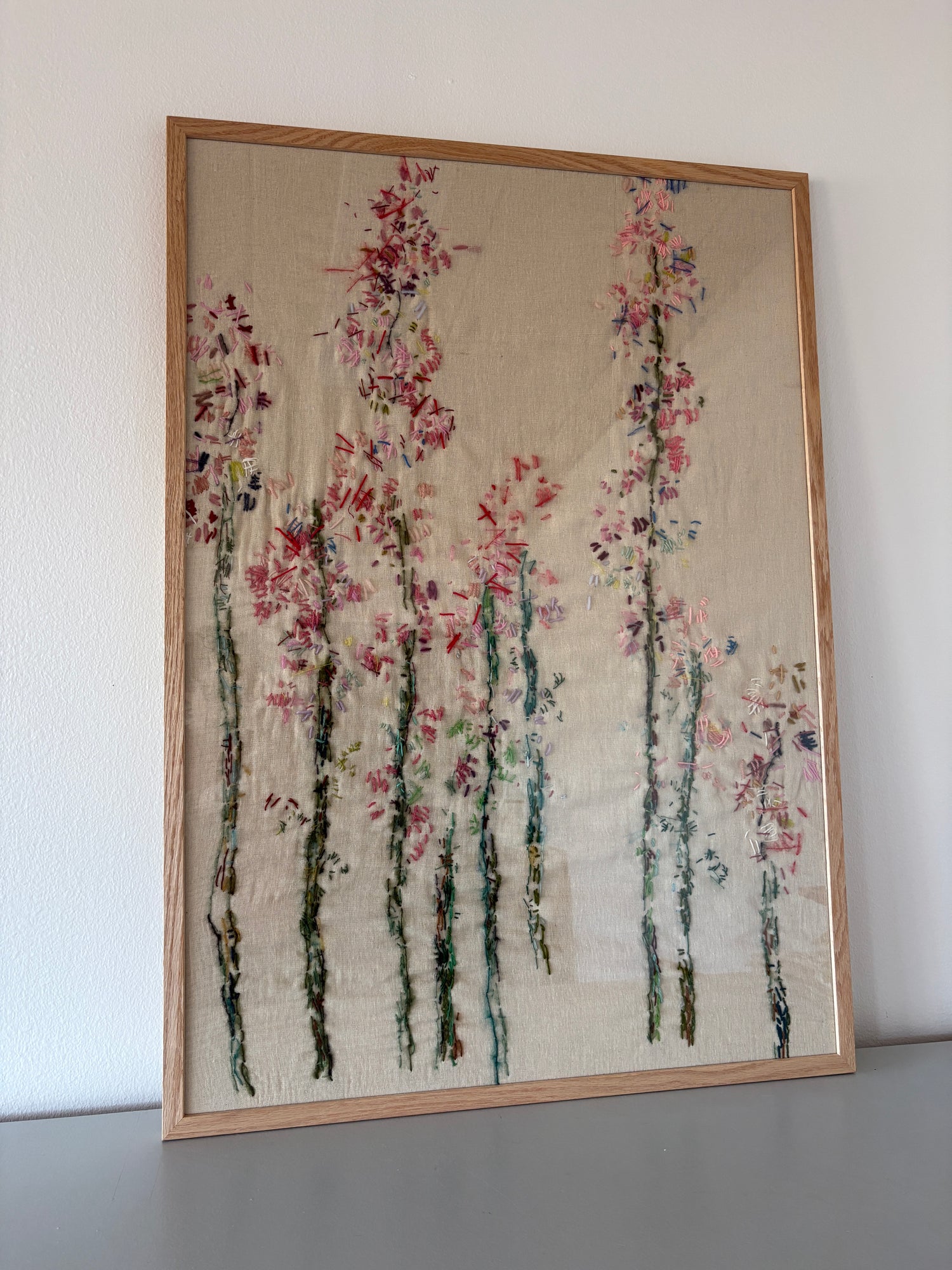 Hand embroidered floral artwork, abstract textile piece in shades of pinks and greens, framed 70x100 cm, by Helle Skaarup Studio