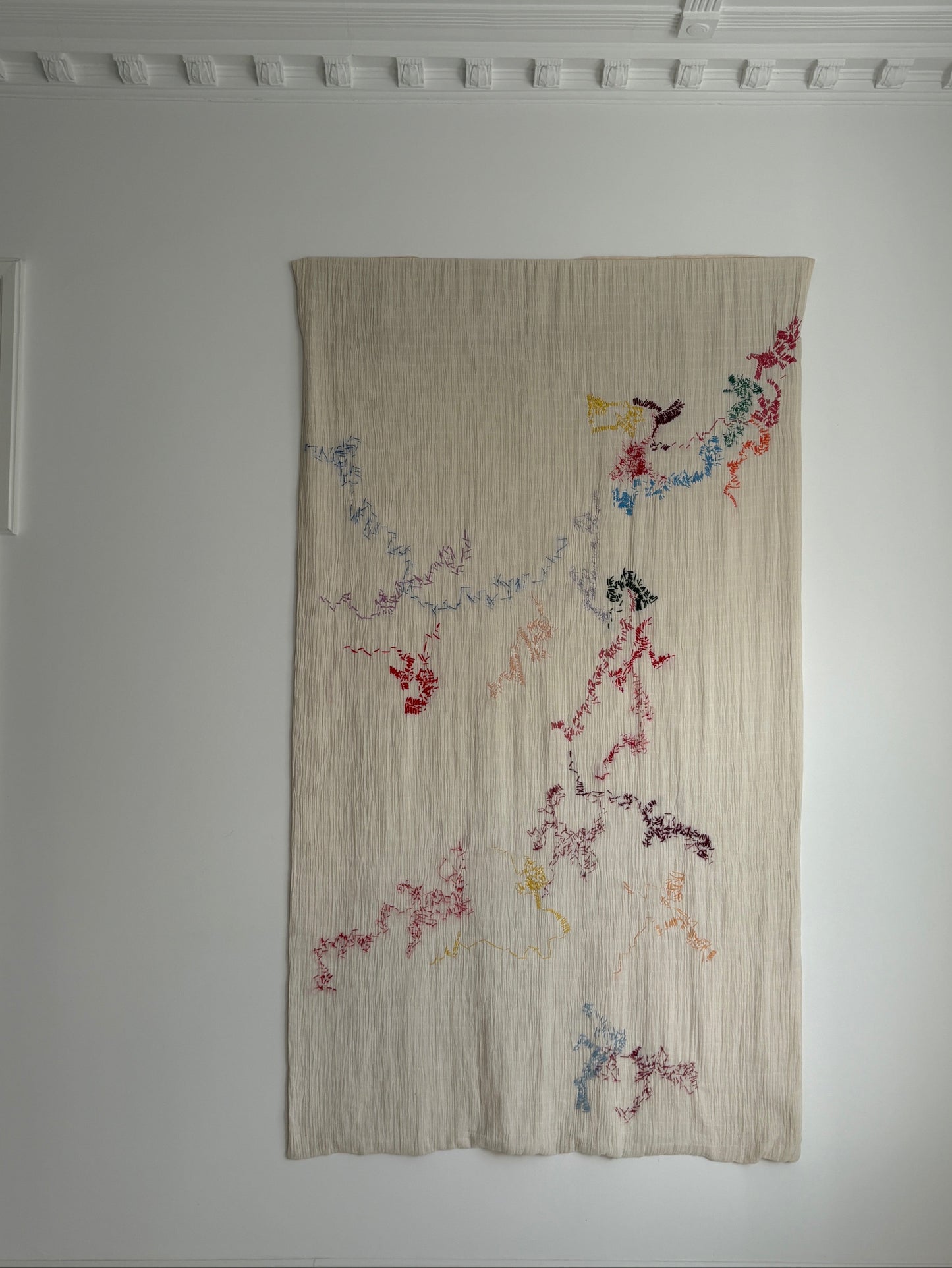 Holly - Handcrafted Wall Hanging, fully hand embroidered 130x200 cm, displayed on a dining room wall.