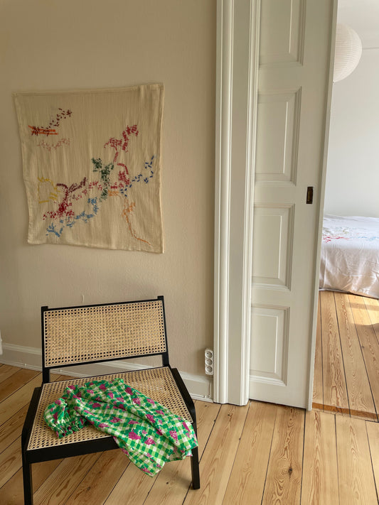 Loulou - Handcrafted Wall Hanging, fully hand embroidered 80x80 cm, displayed on a living room wall.
