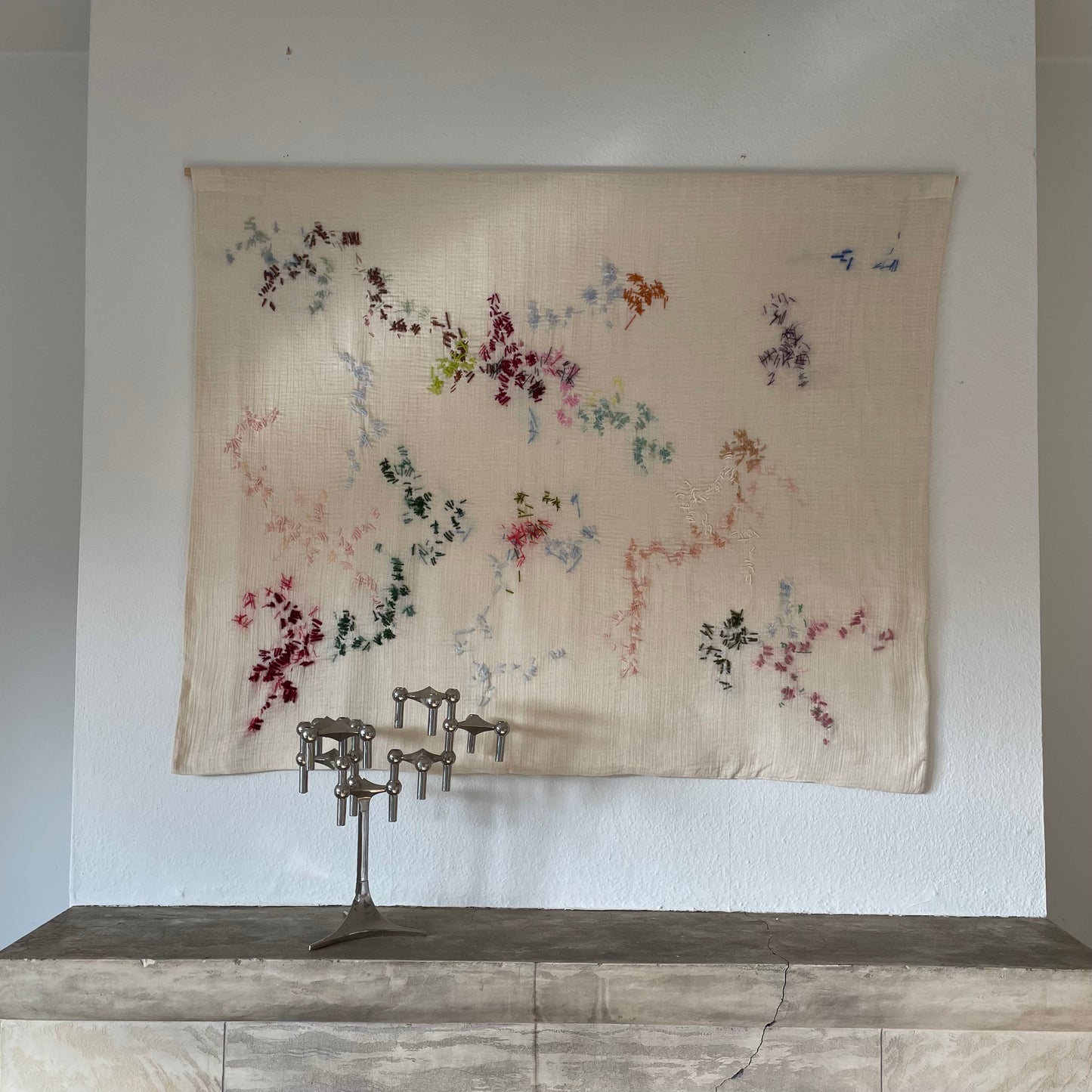 Maina - Handcrafted Wall Hanging, fully hand embroidered 120x100 cm, displayed on a bedroom all.