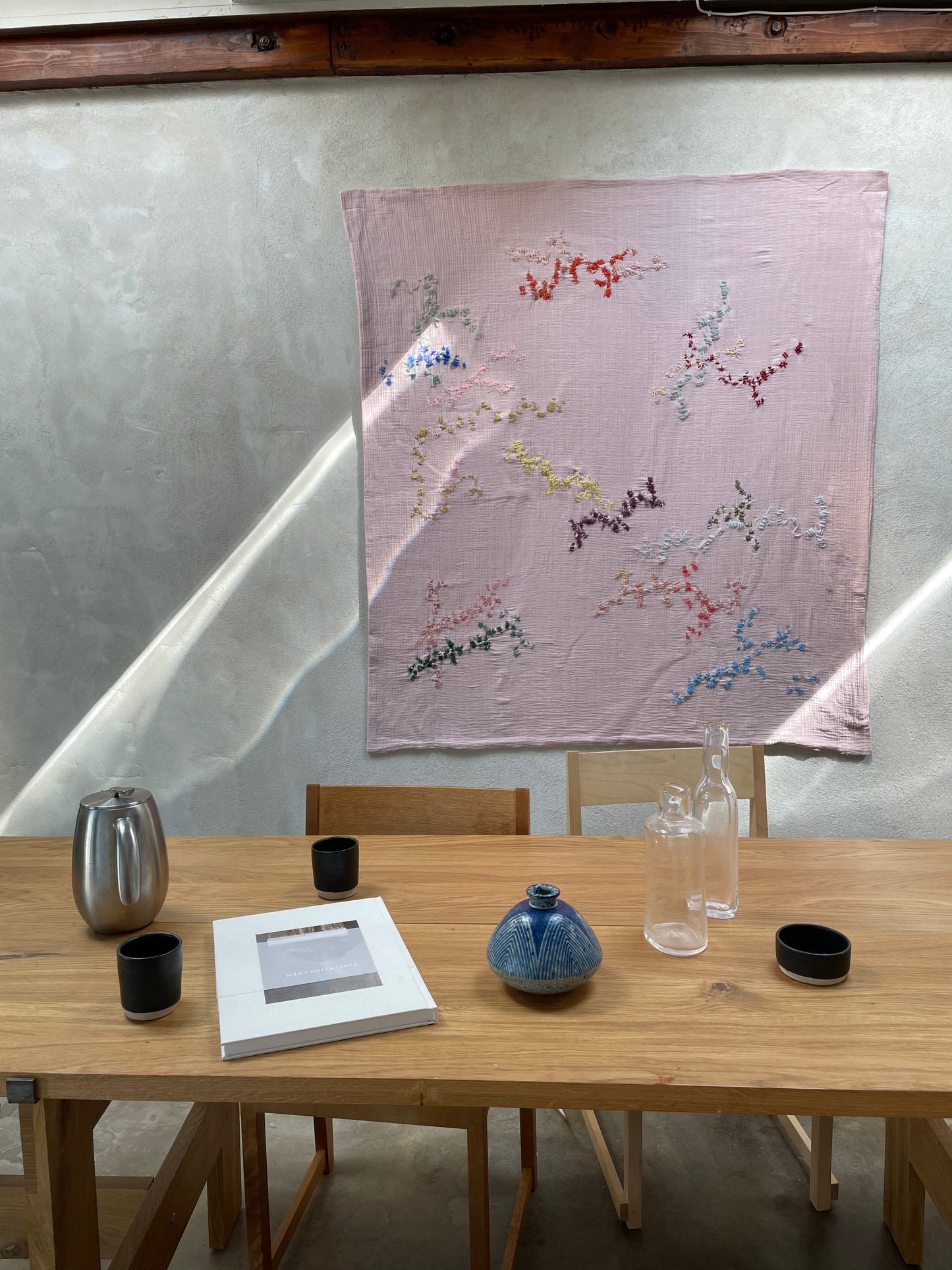 Paris - handcrafted Wall Hanging , fully hand embroidered 130x130 cm, displayed on a dining room wall.